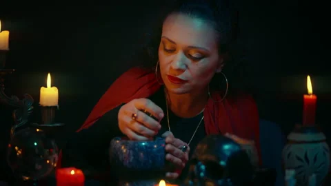 Focused witch cooking magic healing potions, candle light, bewitching someone Stock-Footage 170816794