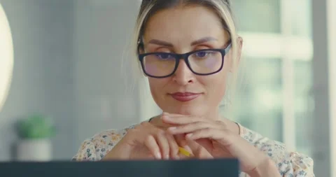 Focused Woman Analyzing Data at Office Desk Stock Footage 323585779