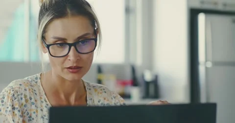 Focused Woman Analyzing Documents at Modern Office Desk Stock Footage 323583516