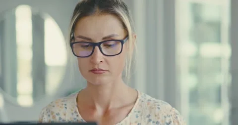 Focused Woman Analyzing Documents in Office Stock Footage 323584914