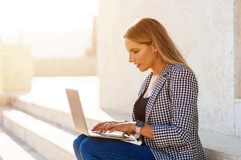 Focused woman browsing netbook during remote work Stock Photos