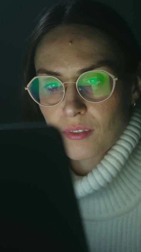 Focused woman in glasses using tablet at night Stock Footage 337830360