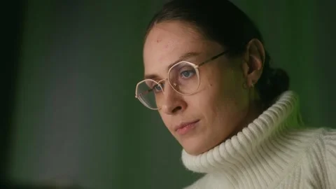 Focused woman in glasses working on computer at night Stock Footage 323897063