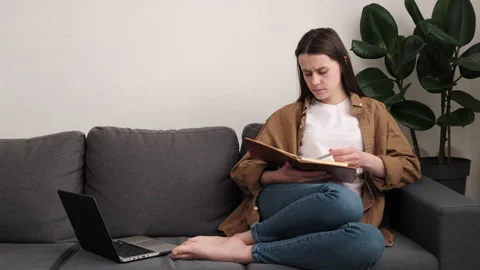 Focused woman work on computer planning agenda, keep diary looking pensive Stock Footage 171658464
