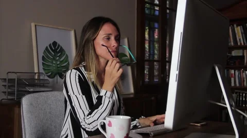Focused Woman Working on Computer and Putting on Glasses at Home Office Stock Footage 124723634