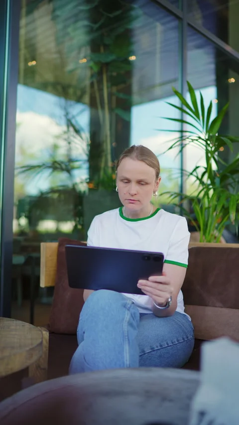 Focused Woman Working on Tablet in Cafe Stock Footage 335456599