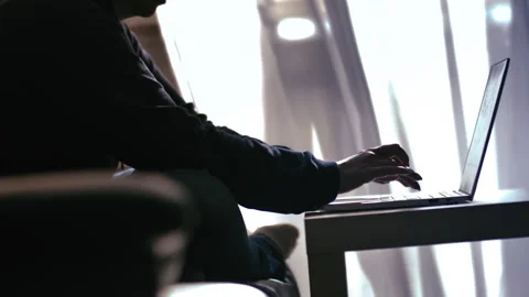 Focused Work Environment: Woman Working Efficiently on Laptop by a Window Stock Footage 319293207