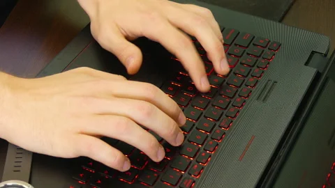Focused Work of a Man Typing on Laptop with Watch Nearby Stock Footage 319012325