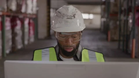 Focused Worker In Hard Hat Sits At Computer Video stock 222004145