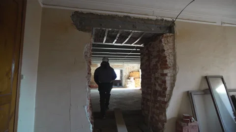 Focused worker walks through corridors of unfinished site Stock Footage 316085564