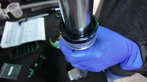 Focused Workshop Scene: Man Assembling Motorcycle Suspension Components 스톡 동영상 327341055