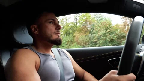 Focused Young Athletic Man Driving Luxury Car on Highway Road Trip Transport 動画素材 347200038