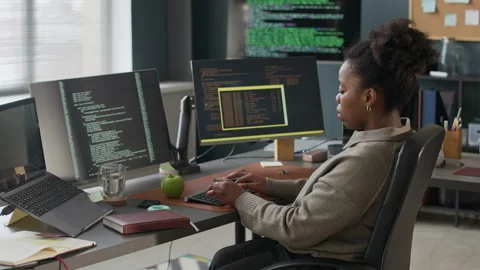Focused Young Black Female Engineer Coding in Modern Programmers Office Stock-Footage 306836480