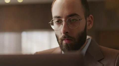 Focused Young Businessman with Beard Working on Laptop Video stock 333631475