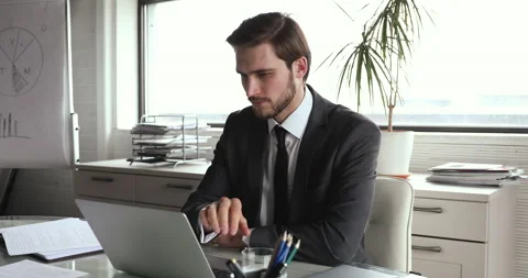 Focused young businessman thinking of problem solution in office. Stock Footage 139517348