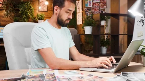 Focused young director working on his laptop in his office Stock Footage 113876280