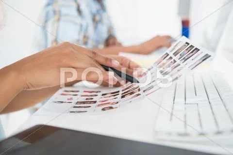 Focused young editorial team working at desk Stock Photos