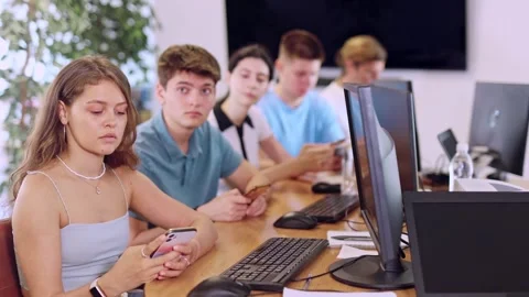 Focused young girl undergoing training in mobile applications development Stock Footage 302726083
