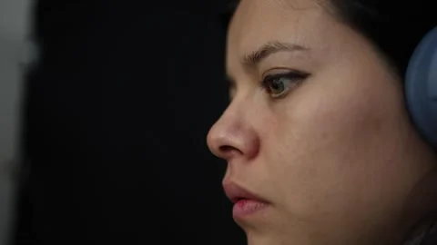 Focused Young Girl Using Computer with Headphones Stock Footage 337532781
