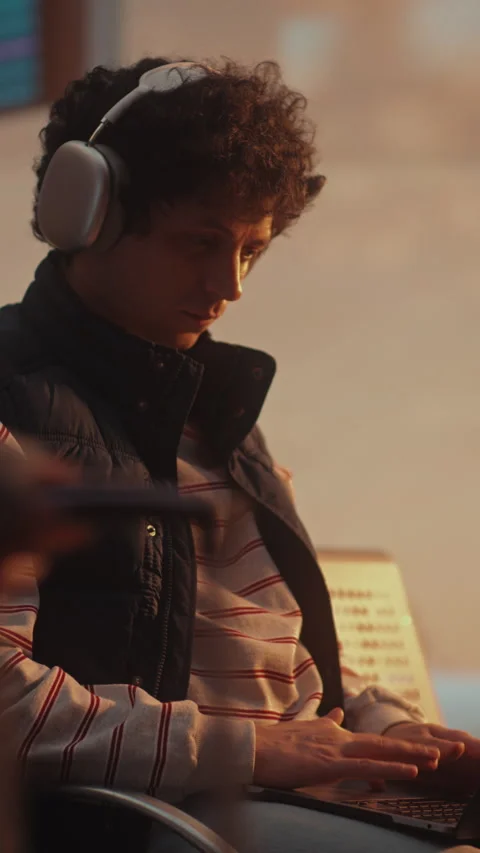 Focused Young IT Developer Coding on Laptop at Airport as Plane Takes Off Stock Footage 332567649