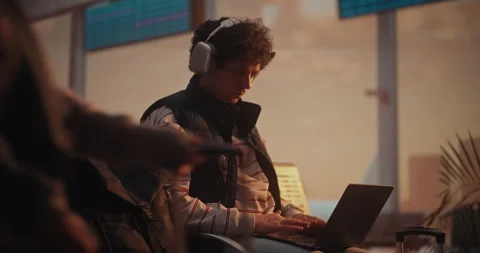 Focused Young IT Developer Coding on Laptop at Airport as Plane Takes Off Stock Footage 332571087