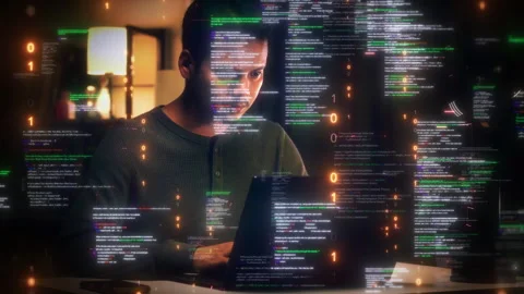 Focused young male developer working on a laptop at night surrounded by flo.. Stock Footage 335191690