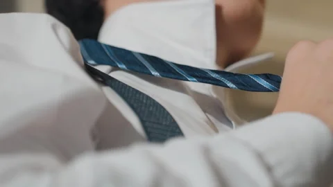 Focused young man adjusting tie. Youthful Asian individual setting up interview Stock Footage 345519603