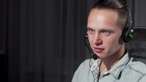 Focused young man engaged in customer support during night shift Stock Footage 311825479