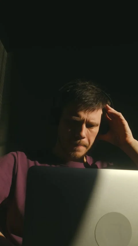 Focused young man with headphones working on laptop Stock Footage 337546452