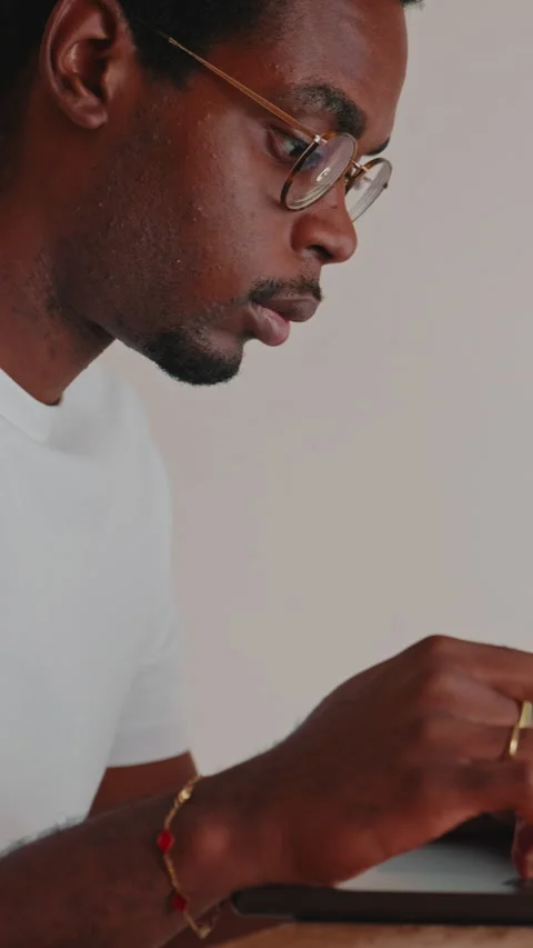 Focused Young Man Typing on Laptop at Home Stock Footage 337105821