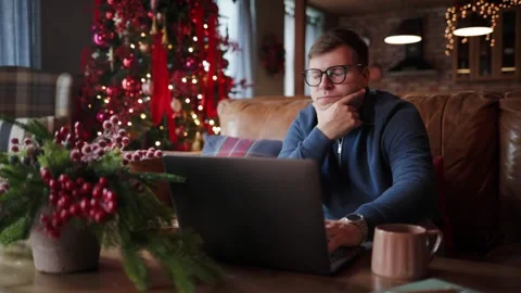 Focused Young Man Using a Laptop at Home, Online Learning,Educational Technology Stock Footage 347694266