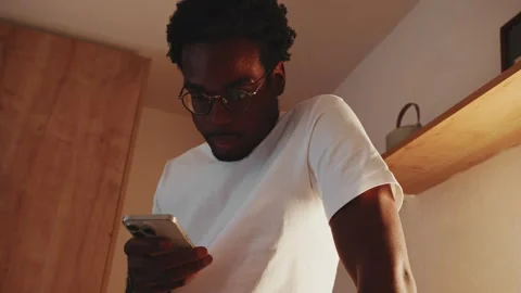 Focused Young Man Using Smartphone Indoors Stock Footage 329934817