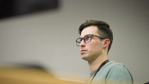 Focused young man working on computer in professional office environment Stock Footage 317541906