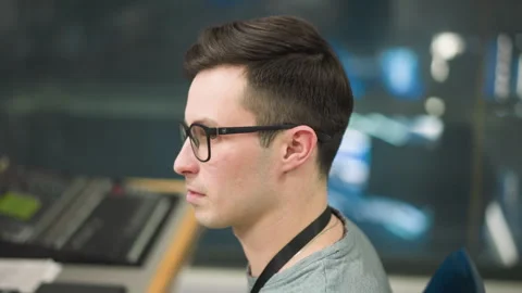 Focused young man working on computer in office studio environment Stock Footage 317590879