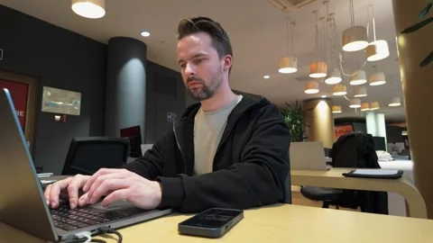 Focused young man working at laptop computer at office workplace Stock Footage 279087488