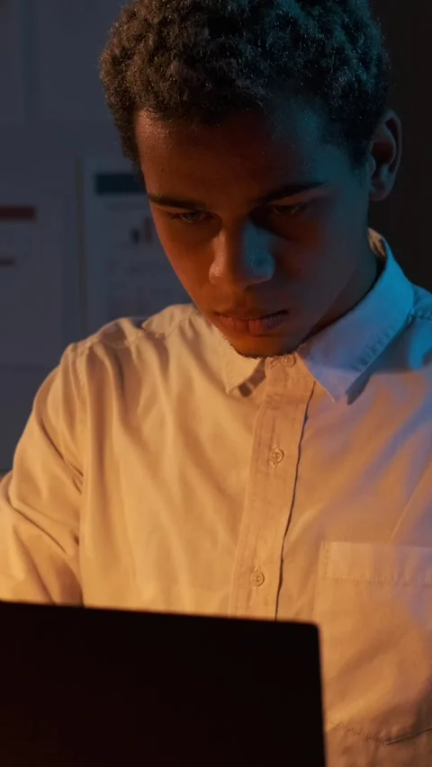 Focused Young Man Working on Laptop at Night Stock Footage 326118952