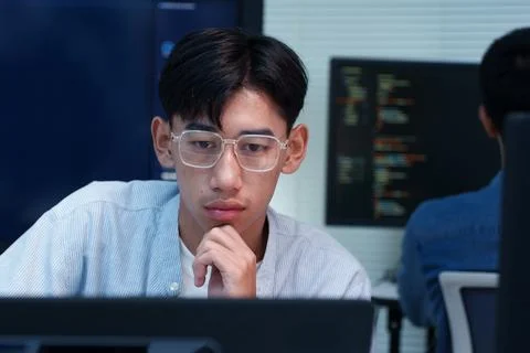 Focused Young Programmer Working on Digital Code Stockfoto's
