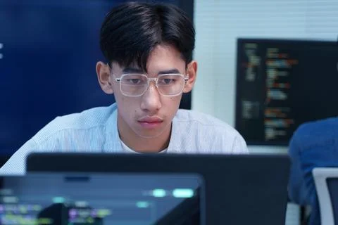 Focused Young Programmer Working on Digital Code Photos