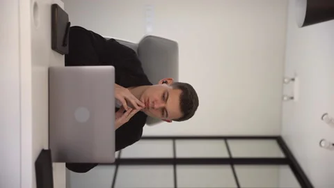 A focused young student man listens to an online lecture. Distance learning Stock Footage 163834599