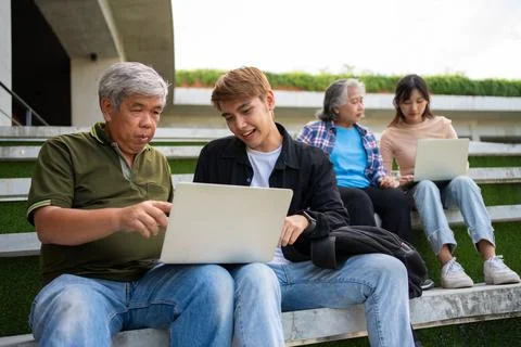 Focused young students listening old senior aged teachers for advise capsto.. Stock Photos