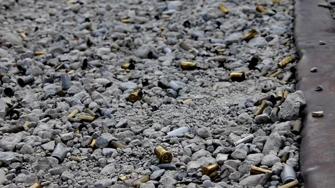 Focusing in on bullet shell casings on the ground Stock Footage 113911481