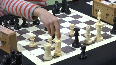 FOCUSING CHILDS HAND PLAYING CHESS Stock Footage 100200315