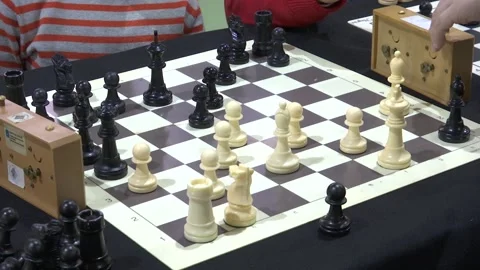 FOCUSING CHILDS HAND PLAYING CHESS Stock Footage 100200320