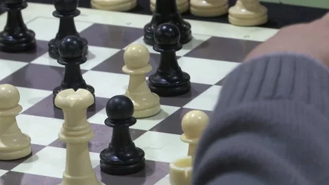 FOCUSING CHILDS HAND PLAYING CHESS Stock Footage 100200333