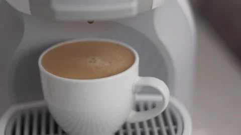 Focusing on a cup of espresso in capsule coffee machine Stock Footage 111138323