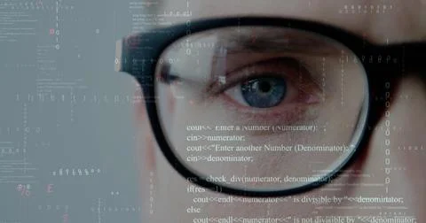 Focusing developer's eye behind black-rimmed glasses at digital interface with Stock Photos