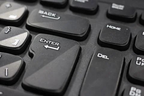 Focusing on "Enter" Key on the Black Keyboard Stock Photos