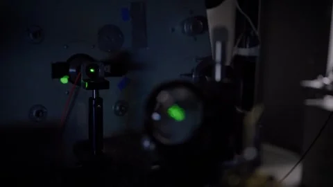 Focusing on a green laser dot Stock Footage 300707020
