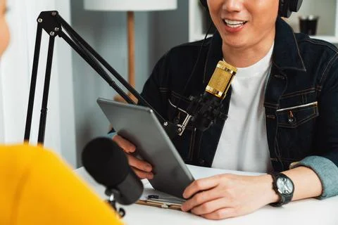 Focusing host holding tablet wearing headphone interview speaker. Infobahn. Stock Photos