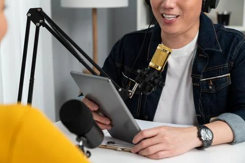 Focusing host holding tablet wearing headphone interview speaker. Infobahn. Stock Photos